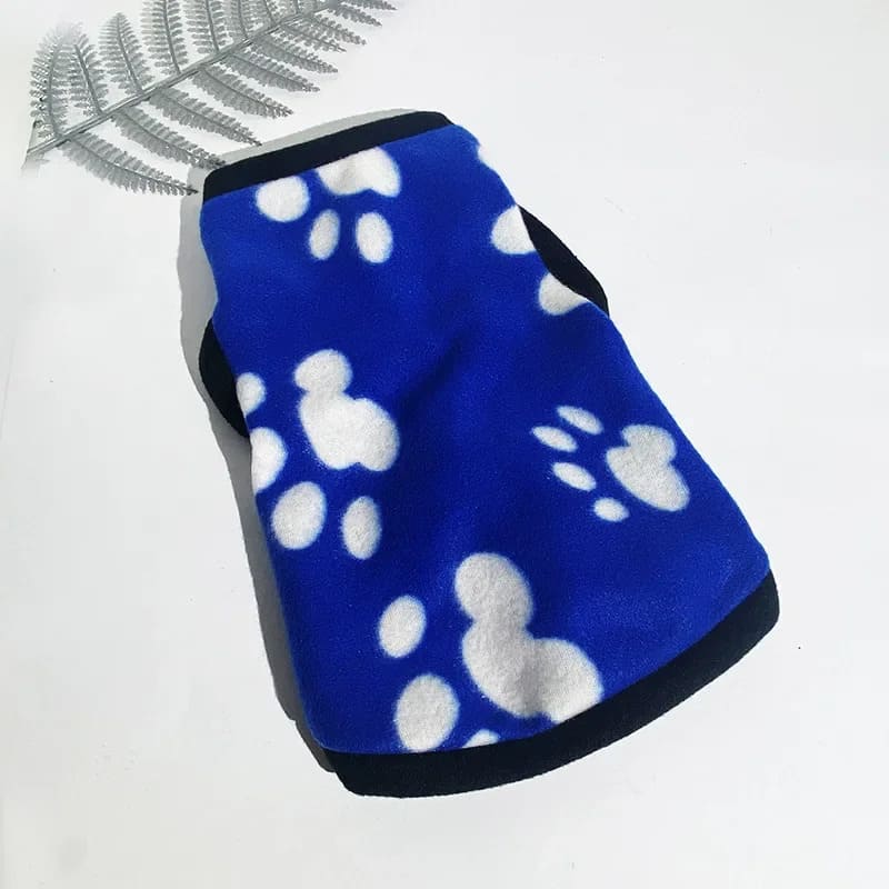 A fleece jacket for pooches in vibrant blue with white paw print patterns, offering warmth and comfort for pets.