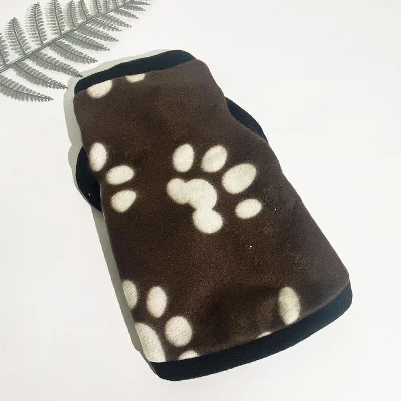 Image of a fleece jacket for pooches, a cozy brown fleece dog jacket adorned with white paw print patterns. The snug and thermal design ensures your pet stays warm during winter months.