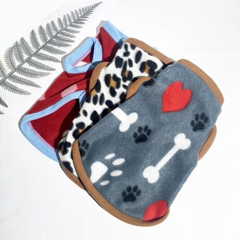 Assorted fleece jackets for pooches with paw, bone, and heart patterns in various colors.