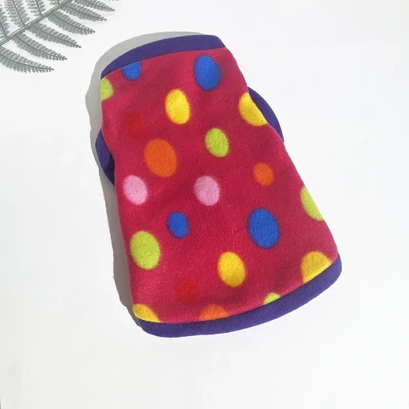 Colorful polka-dotted red fleece jacket for pooches with vibrant multicolored dots and contrasting blue trim.