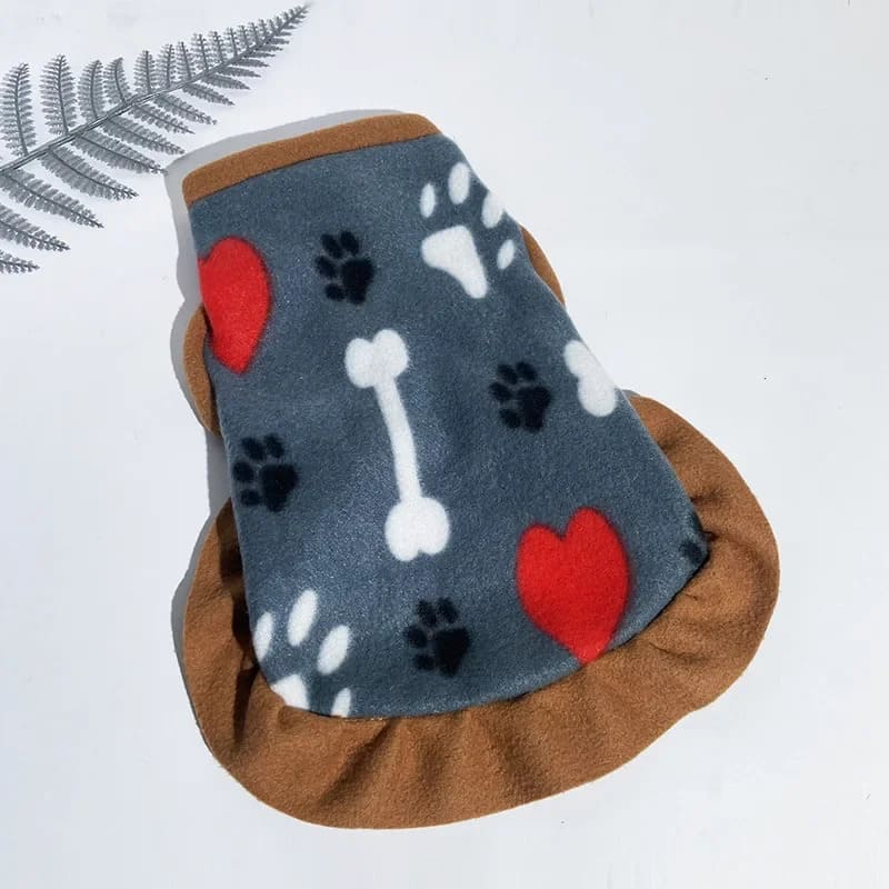 Grey fleece jacket for pooches with white bone and paw print pattern and a prominent red heart, edged with a soft brown trim.