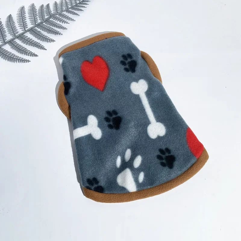 Cozy grey fleece jacket for pooches featuring white paw prints and bones with a bold red heart, trimmed with soft brown edges.