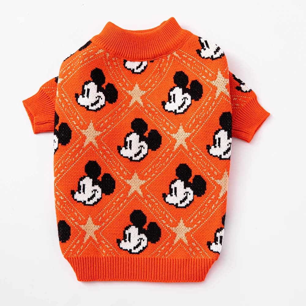 A vivid orange puppy sweater adorned with iconic Mickey Mouse motifs and golden stars, embodying the essence of orange chic pup fashion.