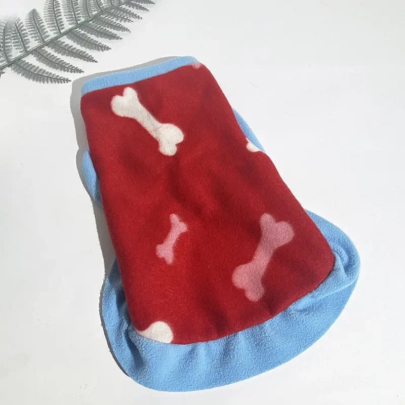 A vibrant red and blue fleece jacket for small dogs featuring a playful white bone pattern, ideal for keeping your pet warm and fashionable.